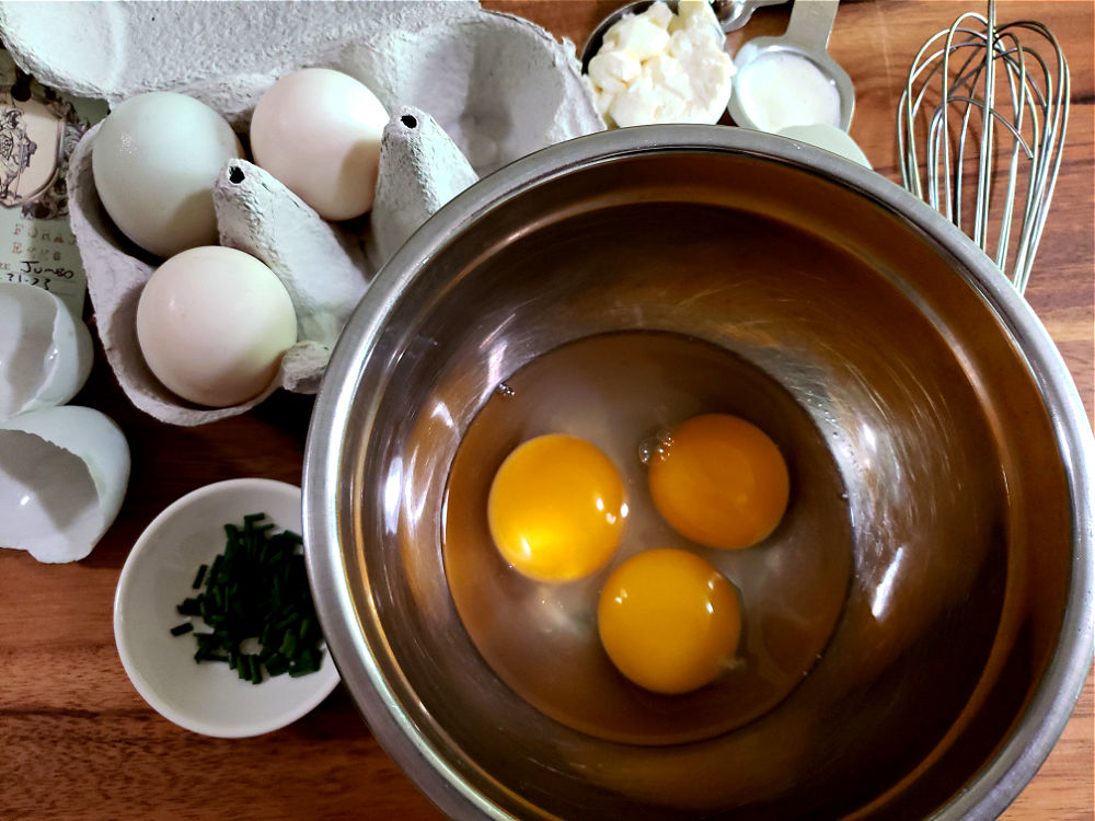 Adding duck eggs to a mixing bowl