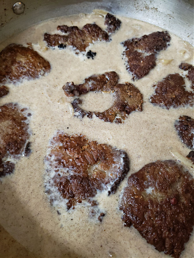 cooked liver pieces nestled in rich gravy simmering