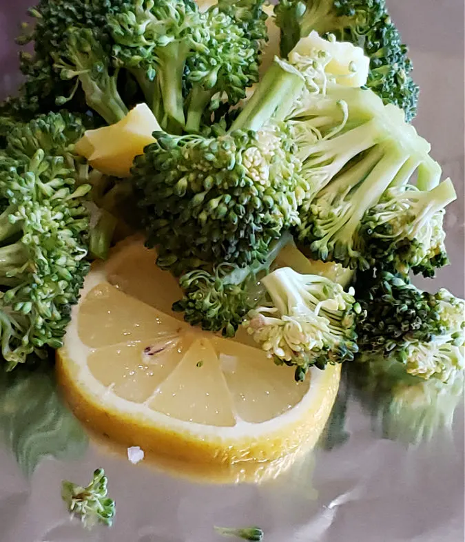 wrap broccoli and lemon slices in aluminum foil