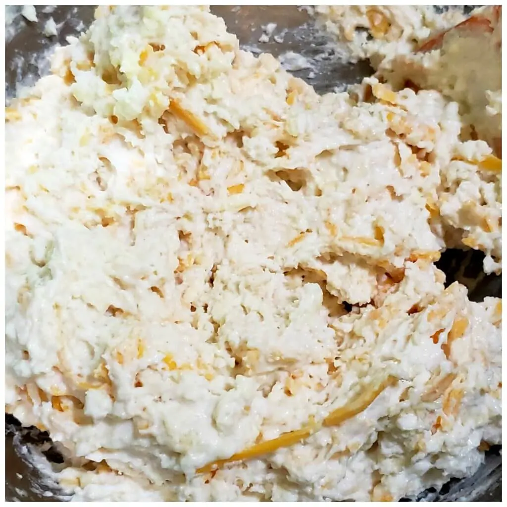 drop biscuit dough with cheese in a mixing bowl