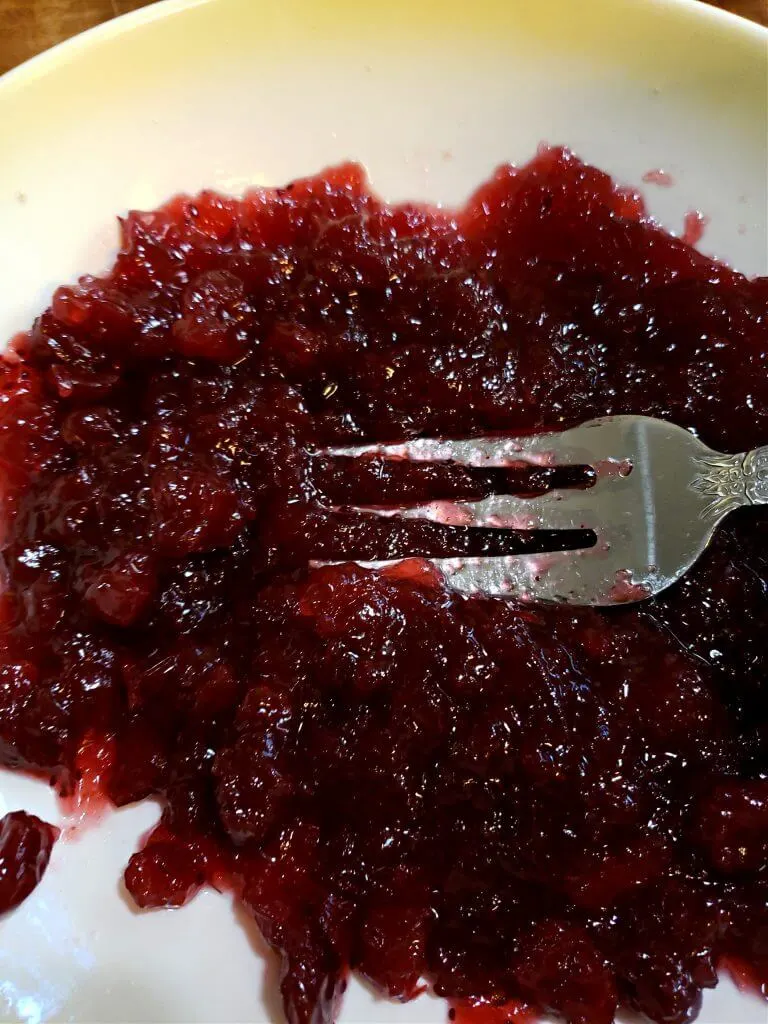 mashing canned cranberry sauce