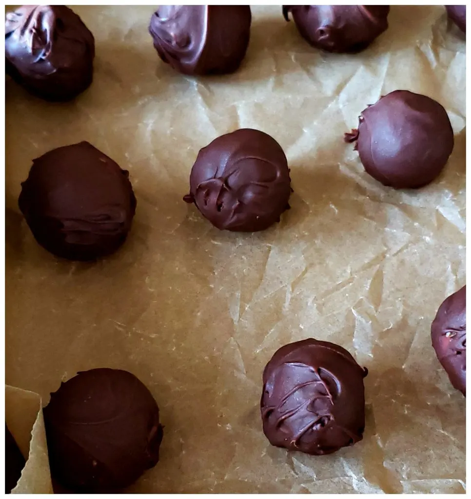 Chocolate dipped candy on a baking sheet