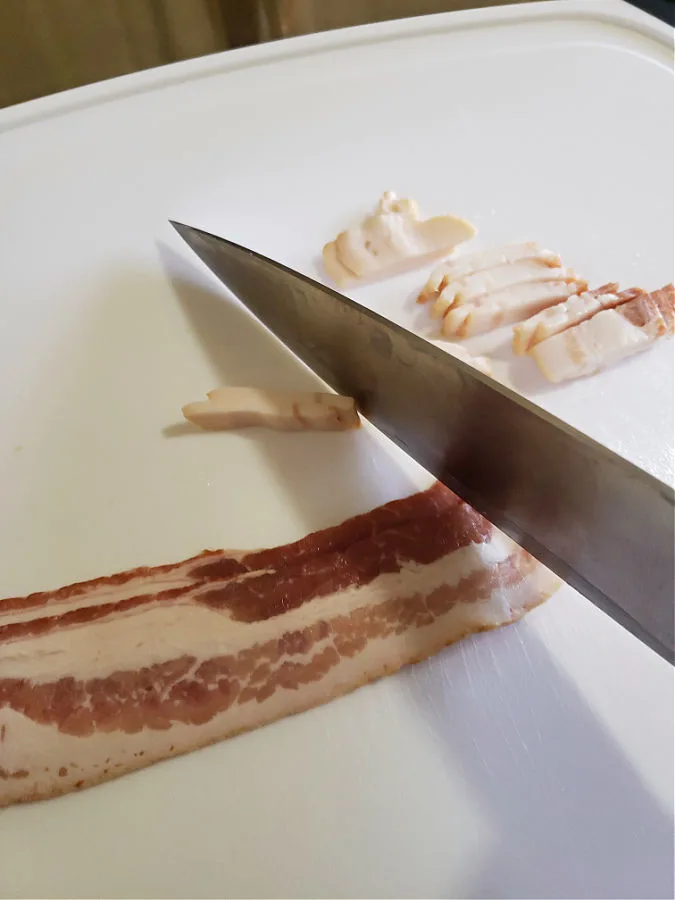 chopping bacon on a cutting board