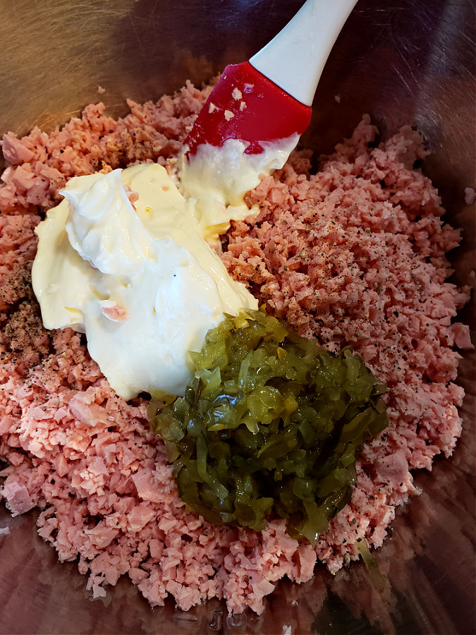 easy bologna salad mixture in a mixing bowl with Duke's mayonnaise and sweet pickle relish