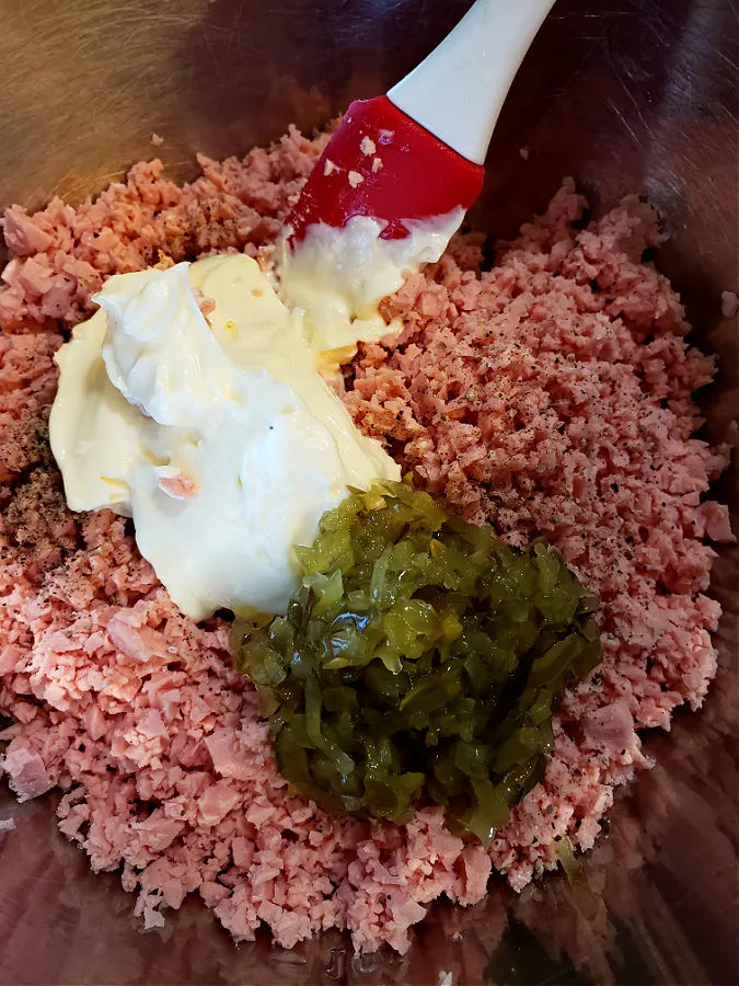 easy bologna salad mixture in a mixing bowl with Duke's mayonnaise and sweet pickle relish