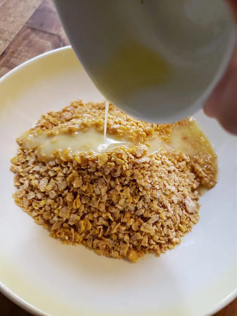making a crushed cereal pie crust with melted butter and corn flake cereal
