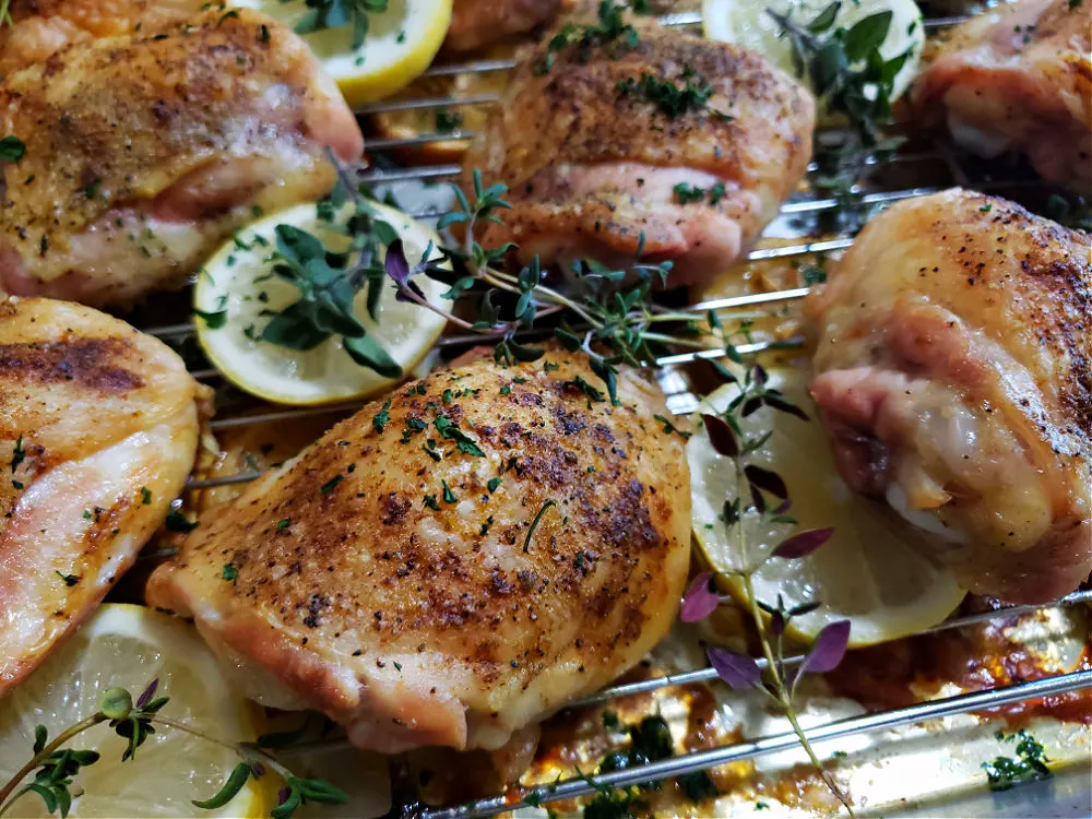 Easy crispy baked chicken thighs fresh from the oven garnished