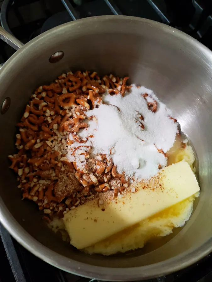 pot with butter, sugar, and crushed pretzels to prepare a crust