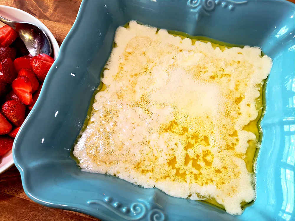 pour cobbler batter into prepared baking dish of melted butter