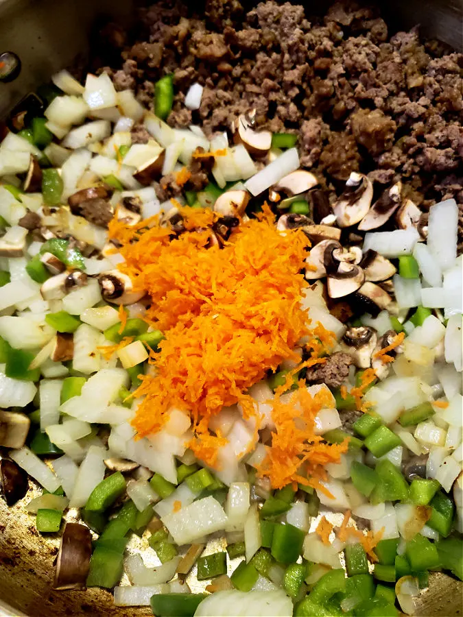 preparing spaghetti sauce in a large pan