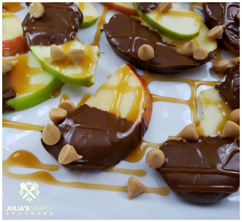 sweet apple nachos with caramel on a white serving platter