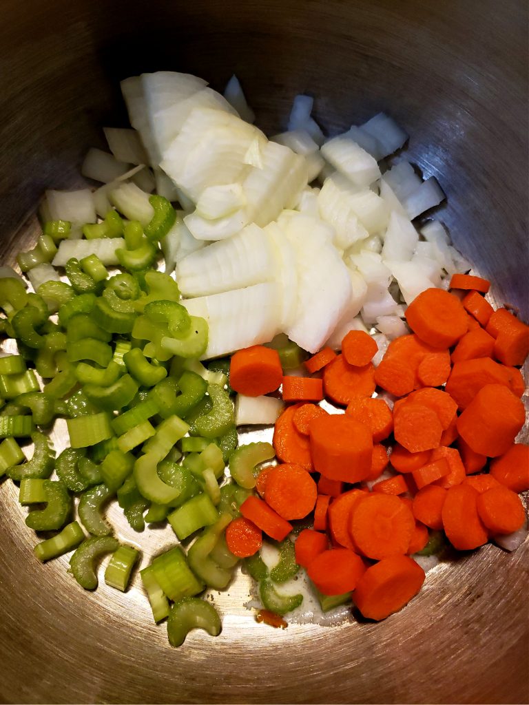 Chopped vegetables in a soup pot 
