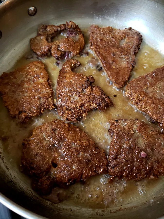 skillet with hot oil frying liver