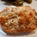 Panko Parmesan Baked Pork Chops on a plate with baked asparagus