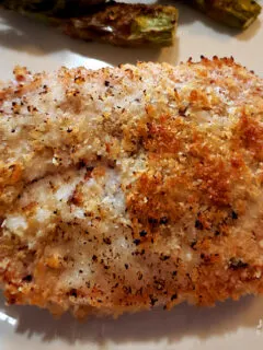 Panko Parmesan Baked Pork Chops on a plate with baked asparagus