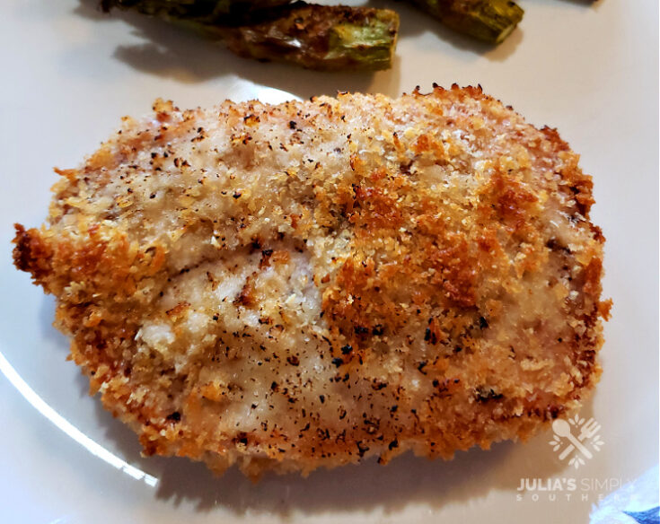 Panko Parmesan Baked Pork Chops on a plate with baked asparagus