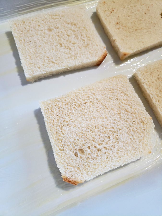 slices of light bread, crust removed, placed into a buttered casserole dish