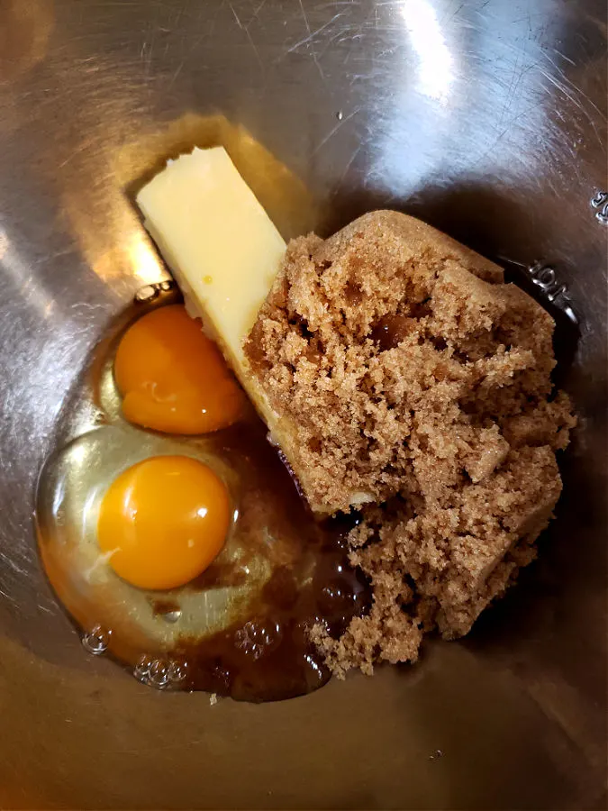 combining wet ingredients in a metal mixing bowl